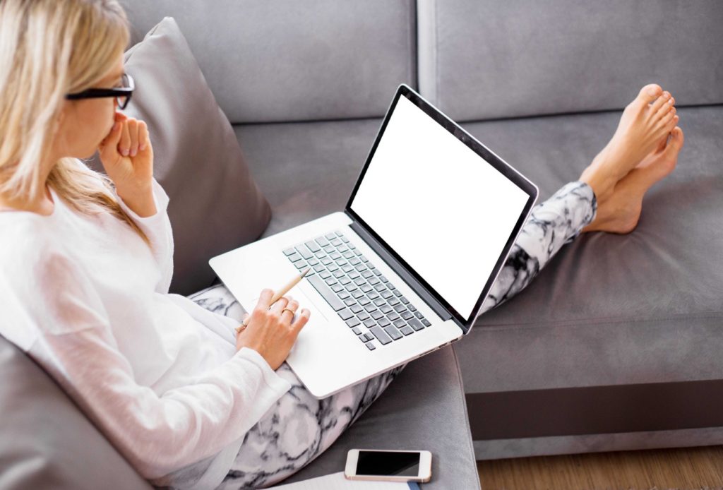 Woman working from sofa, casual remote work from home, Remote Fridays